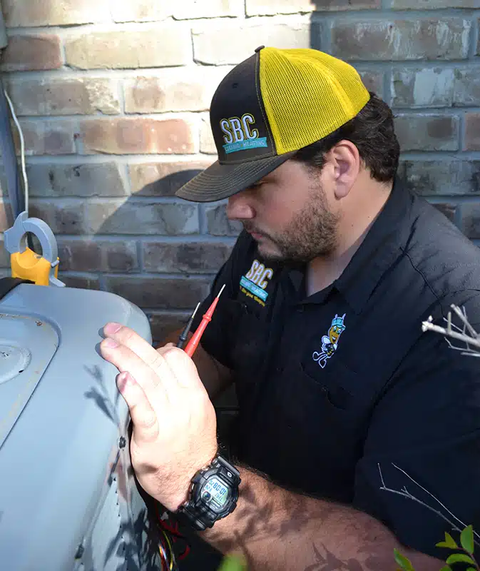 SBC tech working on air conditioner outside of residential home in Shreveport LA