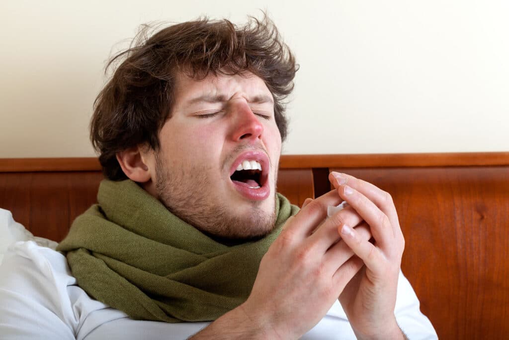 man sneezing